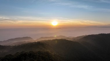 Kencana Dağı 'nın tepesinin üstündeki gökyüzü manzarası, güzel bulutlar ve etrafını kaplayan sis.