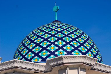 Colorful Mosaic Dome Shines Under the Clear Blue Sky with Architectural Details Beautifully Crafted. clipart