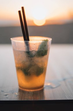 Cctel Mojito con el atardecer de fondo