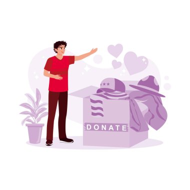 Genç adam ihtiyacı olanlara vermek için karton bir kutuda giysiler topluyor. Bağış konsepti. Modern vektör düz resimleme eğilimi