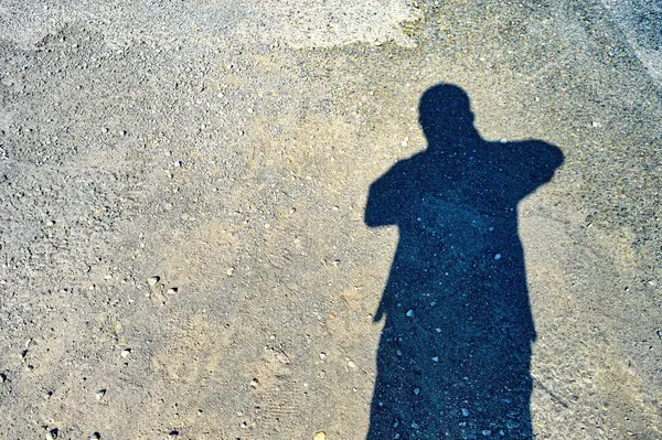 the shadow of a man in hot weather