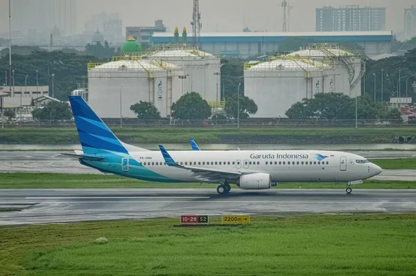 stock image a Boeing B737-8U3 aircraft belonging to the Garuda Indonesia airline is taking off on the runway at Juanda International Airport Surabaya in Sidoarjo during the rain, Indonesia, 6 January 2024