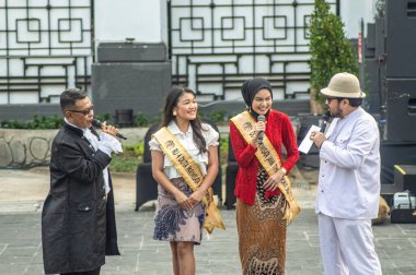 two female tourism ambassadors for East Java who were being interviewed at the soft launching event in the old city of Surabaya, Indonesia, 20 June 2024. clipart