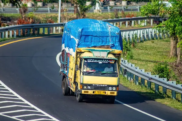 stock image a Mitsubishi Fuso canter truck that transports over-dimensional and over-loaded goods, Indonesia, 16 July 2024.