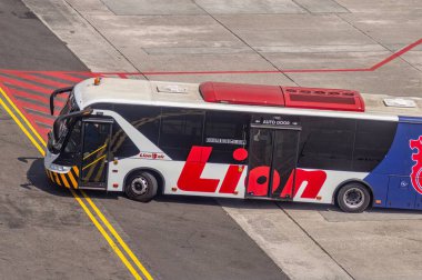 Lion Air bus on airport tarmac, showcasing the airline red and white branding, ready for passenger transport, Surabaya, 22 September 2024. clipart