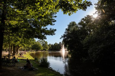 Visitors Enjoying a Sunny Afternoon in Vondelpark - Amsterdam, Netherlands