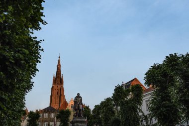 Simon Stevin Statue with Church of Our Lady Spire at Dusk - Bruges, Belgium