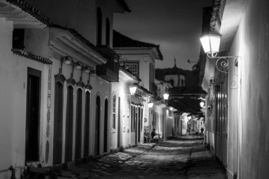 Black and White View of Historic Alleyway Illuminated by Street Lamps in Paraty, Brazil