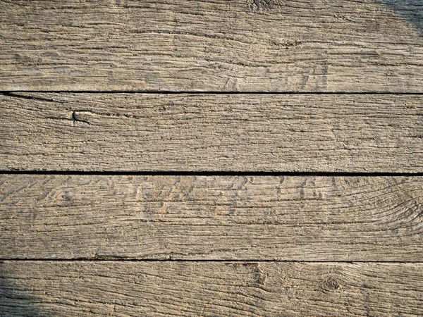Old weathered damaged rustic vintage wooden flooring panel texture for background, soft golden hour light
