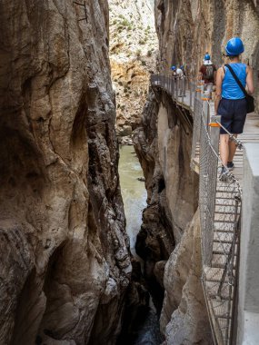 Endülüs, Malaga, İspanya 'daki El Caminito del Rey vadisinde yürüyüş yapan genç bir bayan turist.