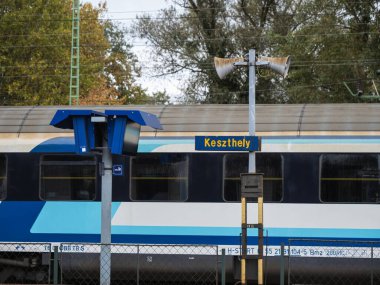 Keszthely, Hungary - October 21, 2023: MAV hungarian train carriage on a platform near the Balaton lake at Keszthely, rail transport, holiday high season, late, delay clipart