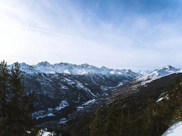 stock image A panoramic view of Serre Chevalier Briancon ski resort in the French Alps. Snow-covered peaks, evergreen trees, and a clear sky create a perfect winter scene for skiing and outdoor adventures.