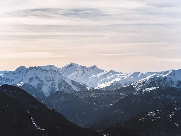 stock image A stunning view of the snow-covered Serre Chevalier peak in Briancon , set against a clear blue sky. The rugged mountain landscape showcases the beauty of the French Alps in winter close to sunset