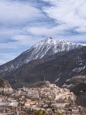 The historic town of Briancon, France, set against the dramatic snowy peaks of the Alps. A central hub of the Serre Chevalier ski resort, blending culture and alpine adventure. clipart