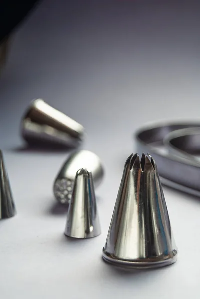 stock image Baking tools, variety of piping tips on a grey background