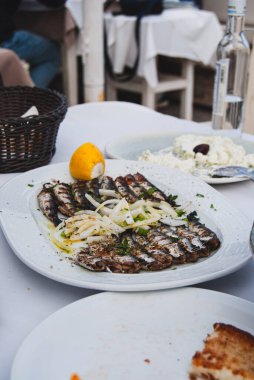 Limonlu, otlu, soğanlı, sardalyalı ızgara balık.