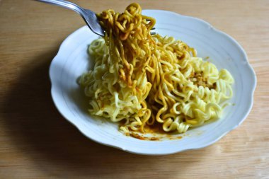 beyaz tabakta çatallı makarna