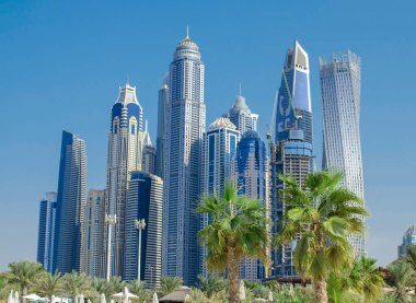 Dubai Marina with skyscrapers and palm trees in Dubai, United Arab Emirates