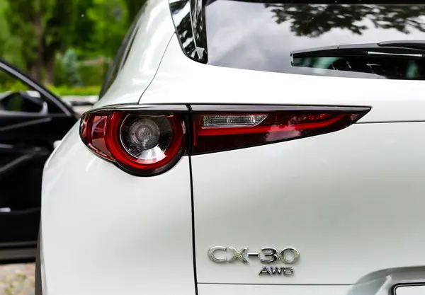 stock image Kyiv, Ukraine 05/29/2024 - A close-up view of the rear of the Mazda CX-30 AWD, showing off the stylish design of the red taillights and chrome branding. The Mazda CX-30, a popular compact SUV, is known for its elegant looks and advanced features.