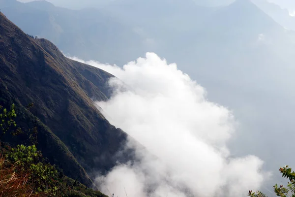 stock image beautiful tall rock mountain top view with clouds under in munnar, kerala india