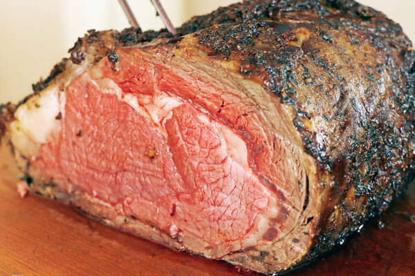 Roasted american angus beef rib eye steak on a meat carvery food station