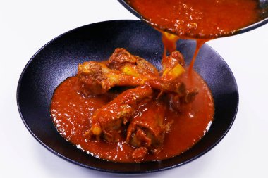 slow cooked indian lamb or mutton shank curry, also known as nalli rogan josh, 	