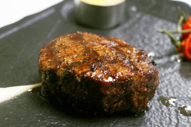 beef tenderloin fillet steak in serving plate in close up clipart
