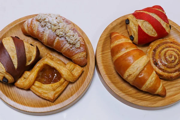 French pastry cake- Danish roll, scone, muffin and croissant displayed in a wooden board