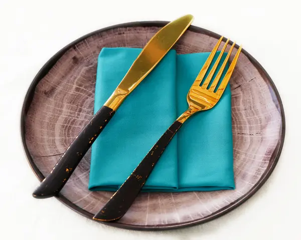 isolated dining cutlery and crockery set, knife and fork on a serving plate