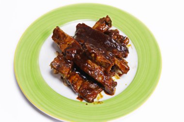 barbeque sauce glazed char grilled pork spare ribs in a plate clipart