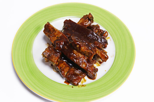barbeque sauce glazed char grilled pork spare ribs in a plate