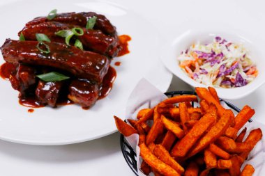 sticky barbecue pork ribs with sweet potato and coleslaw clipart