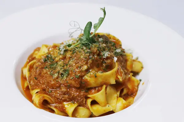 stock image italian pasta with minced beef ragu known as bolognese sauce in serving plate