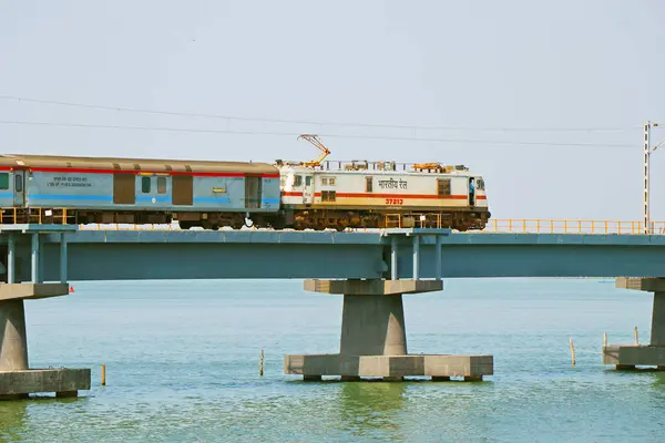 stock image Kochi, Kerala, India -January 15, 2020 a train moving on a bridge with electric support in indian railway