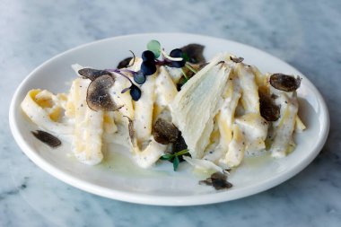 İtalyan yemeği makarna, tagliatelle mantar sosu. Yemek masasının üstünde.