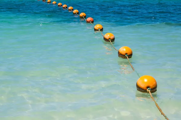 stock image row of balloons floating on water to mark swimming boundaries in the sea during the morning