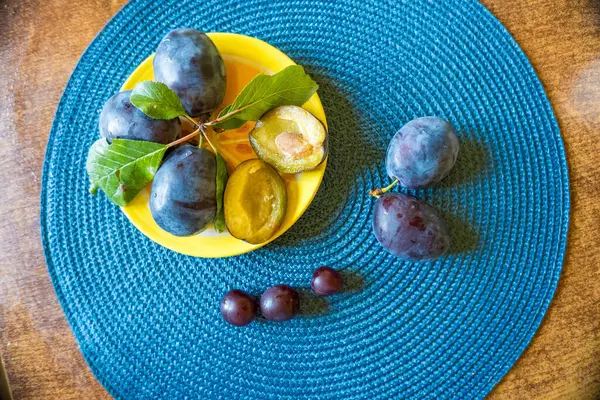 sweet, fragrant dark blue plum, amber I also halved plums. High quality photo