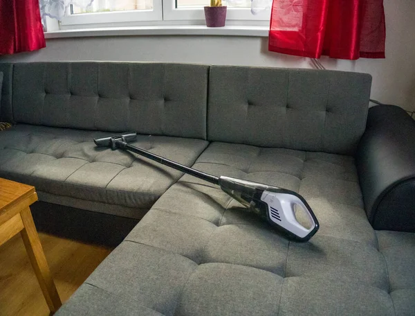 handheld vacuum cleaning on sofa. High quality photo