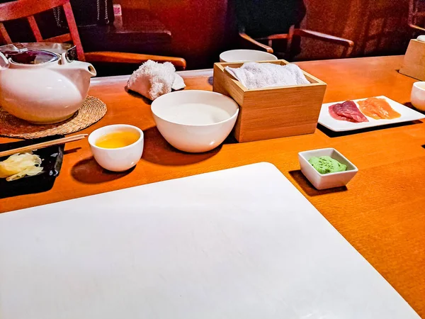Preparing to Make Sushi with Traditional Japanese White Tea over bamboo table. High quality photo
