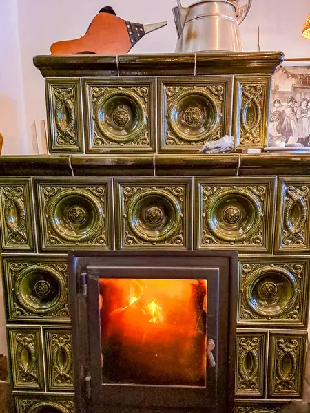 Burning firewood in fire-box of fireplace in country cottage. Rustic cooking oven with burning logs. High quality photo