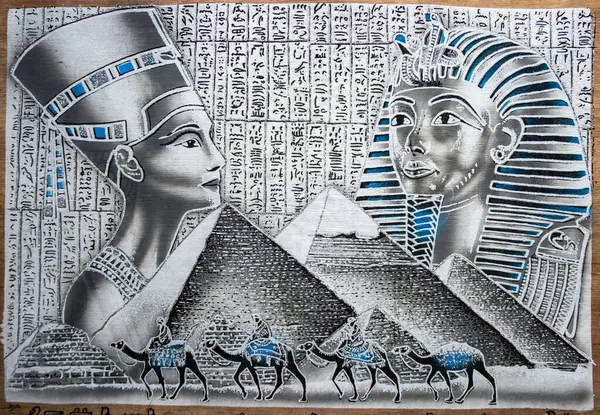 Ancient Egyptian illustration and hieroglyphs engraved and painted on a old papyrus. Painting of Nefertiti and Ramsches from the pyramid. High quality photo
