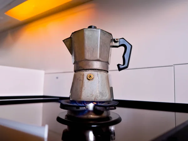Boiling Coffee on gas in kitchen. Moka pot, italian traditional coffee maker, on the stove. High quality photo
