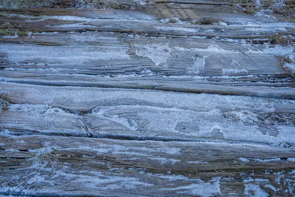 Large horizontal photo. wooden boards. frost on an old wooden staircase. nails in the boards close-up. macro. cold winter. frosty wood. silver glare on a wooden canvas. Horizontal Image Copy Space.
