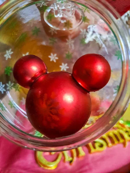 Yeni Yıl Gecesi Mickey Mouse, Cam Topta Oyuncak Yaklaş. Yeni yıl oyuncakları beyaz arka planda bir ipe asılıydı. Yüksek kalite fotoğraf