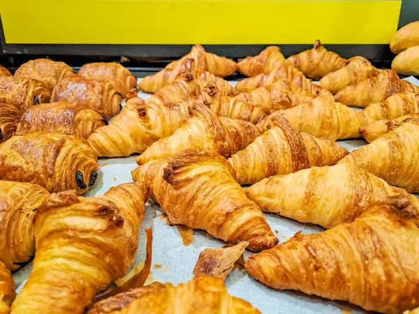fresh golden French croissant from the baking sheet. Fresh classic pastries. High quality photo
