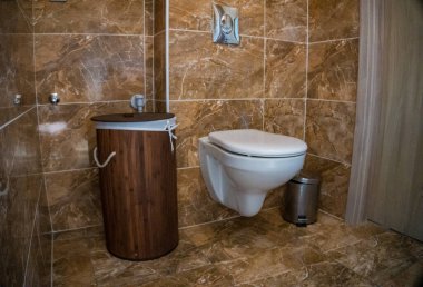 Kahverengi kiremit kaplamalı banyo, bambu sepsiyonu ve beyaz tuvalet. Yüksek kalite fotoğraf