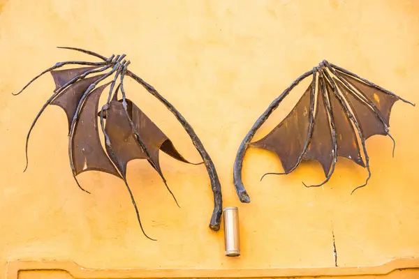 stock image The wings of a bat are like a decoration above the doors of the old castle in Podebrady. Czech Republic. High quality photo