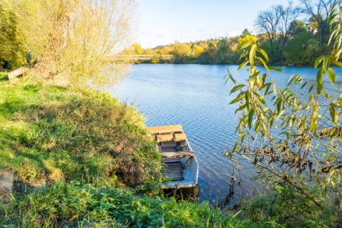 Beautiful view of a boat on the Berounka river in autumn, forest and mountains, Czech Republic. High quality photo clipart