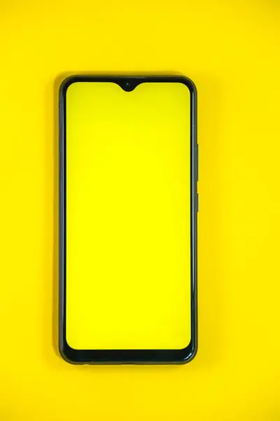 stock image yellow screen template smartphone mockup isolated on yellow background