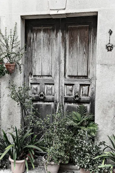 Old wooden door of a house in the village of Valldemossa Mallorca Balearic Islands Spain. Black and white effect